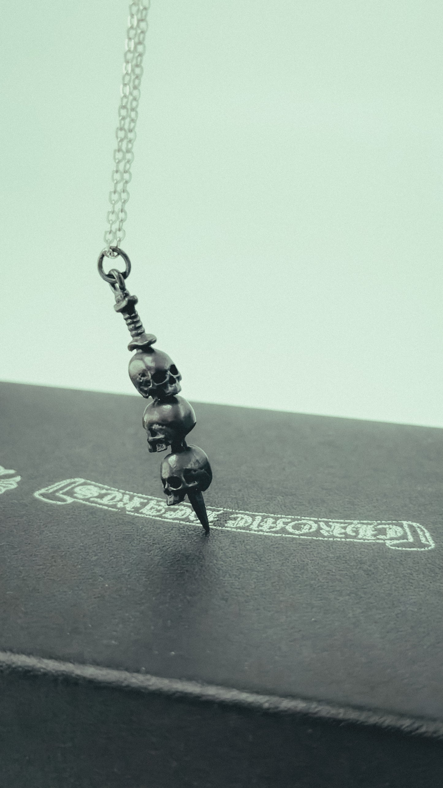 Triple Skulls Piercing Sword Necklace